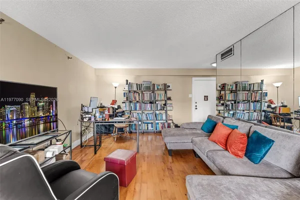 a living room with lots of furniture and white walls