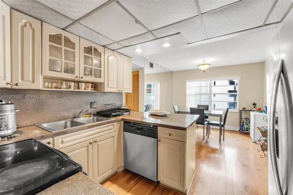 a kitchen with stainless steel appliances granite countertop a stove and cabinets