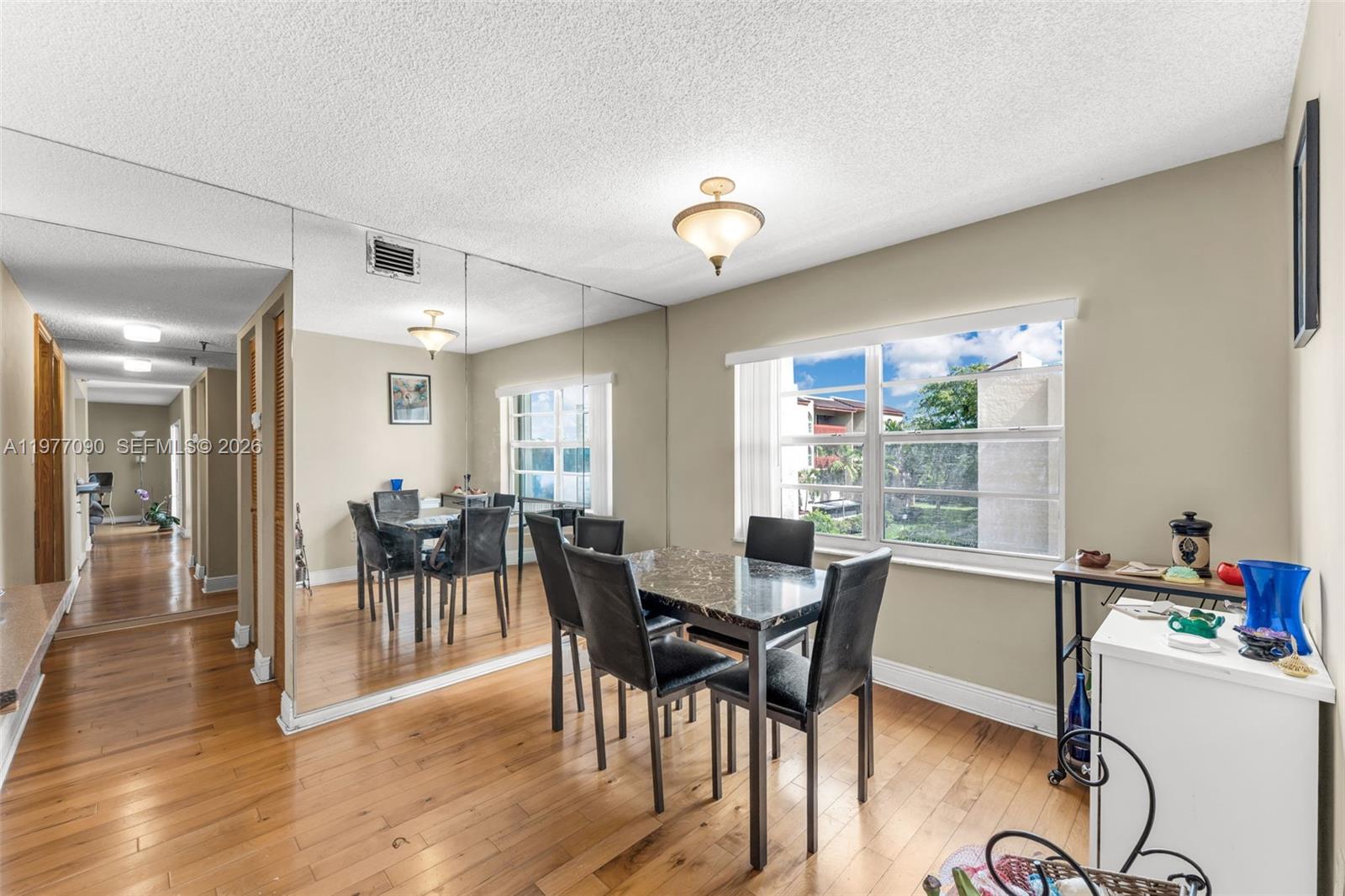 10641 Southwest 108th Avenue, Unit 3D Miami, FL 33176 - Photo 9 of 26 a view of a dining room with furniture and wooden floor