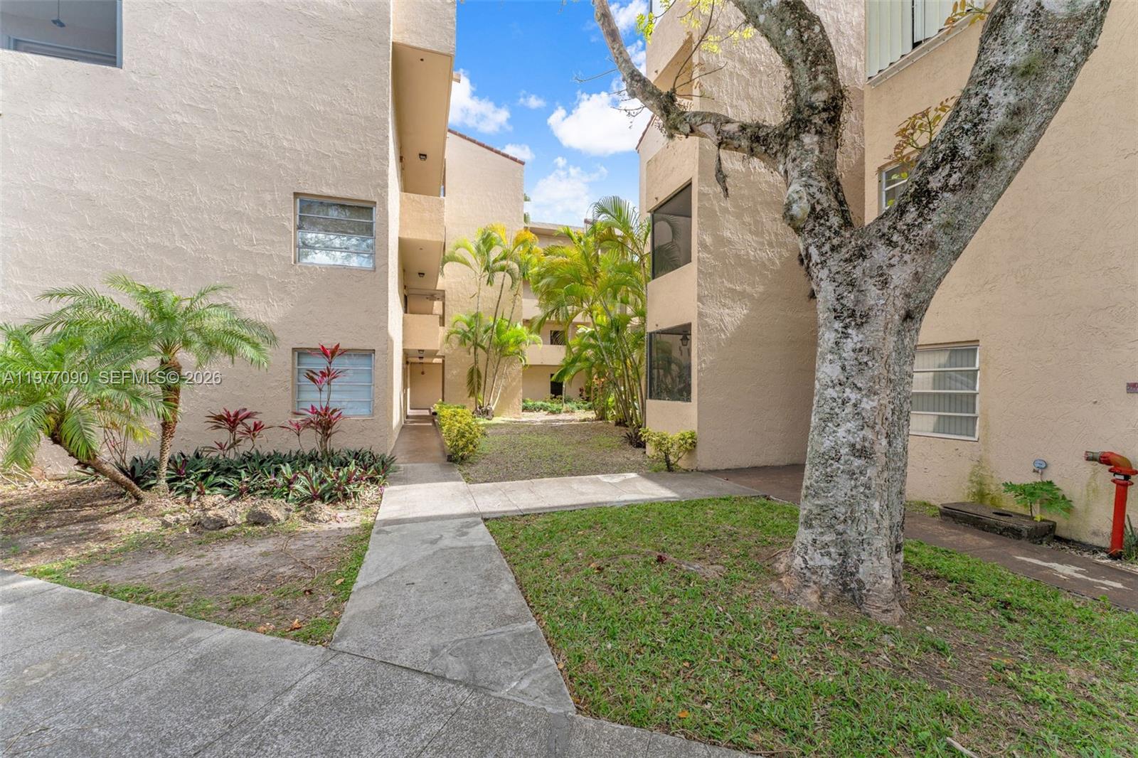 10641 Southwest 108th Avenue, Unit 3D Miami, FL 33176 - Photo 10 of 26 a front view of a house with garden