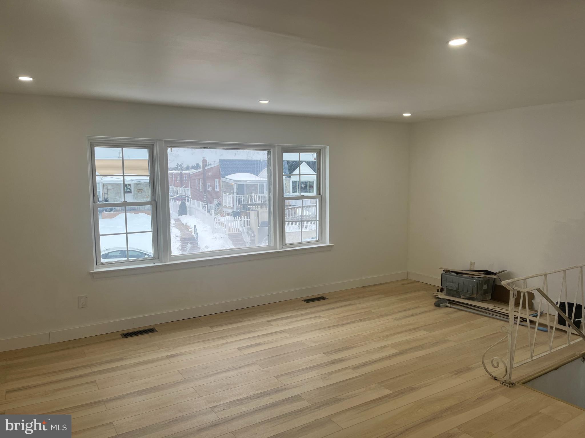 2637 Tremont Street Philadelphia, PA 19152 - Photo 3 of 15 an empty room with wooden floor and windows