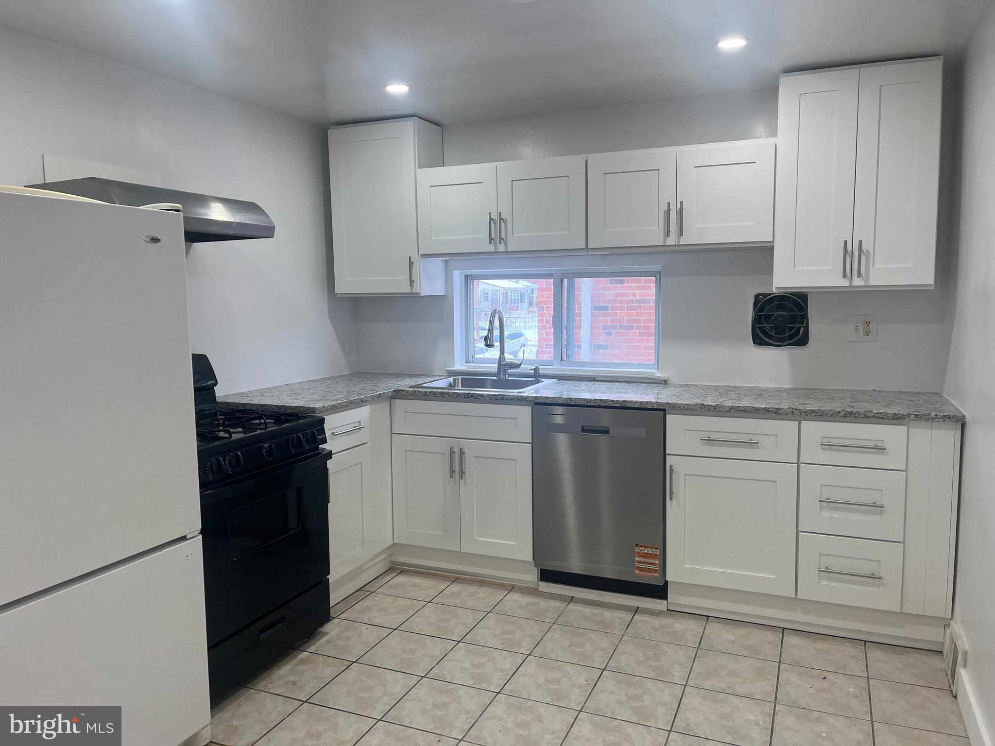 2637 Tremont Street Philadelphia, PA 19152 - Photo 4 of 15 a kitchen with a stove sink and cabinets