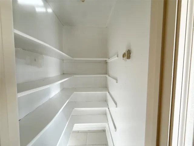 a view of staircase with white walls and a window