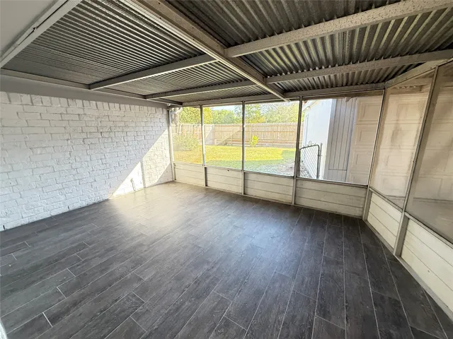 a view of room with wooden floor