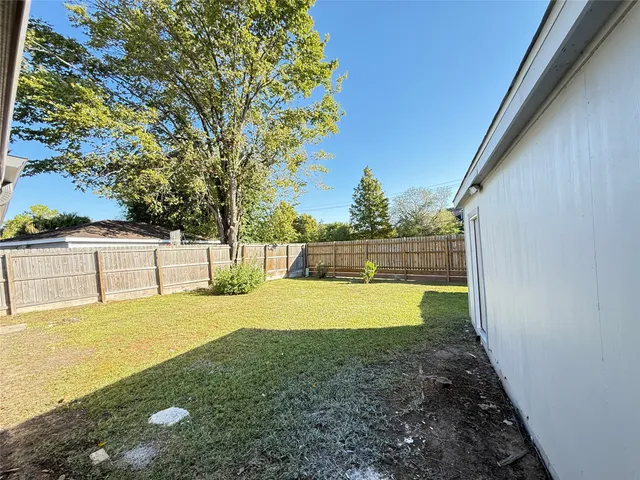 a view of yard with swimming pool and seating area