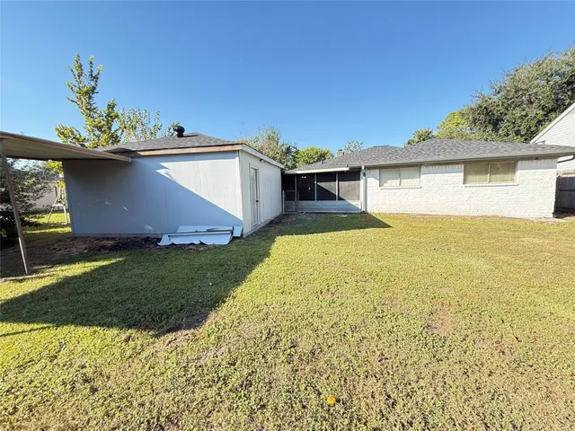 a view of a house with a backyard and a garden