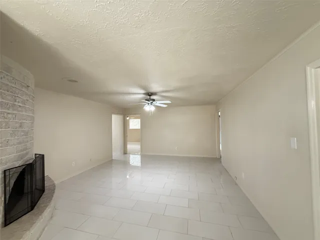 a view of an empty room with a fireplace