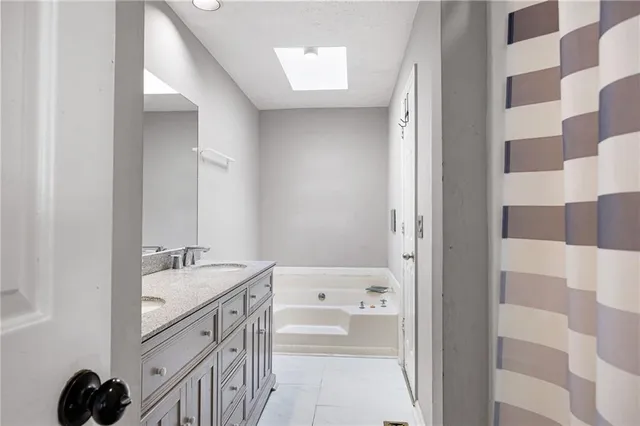 a bathroom with a double vanity sink and mirror