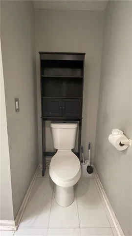 a white toilet sitting next to a bathroom sink