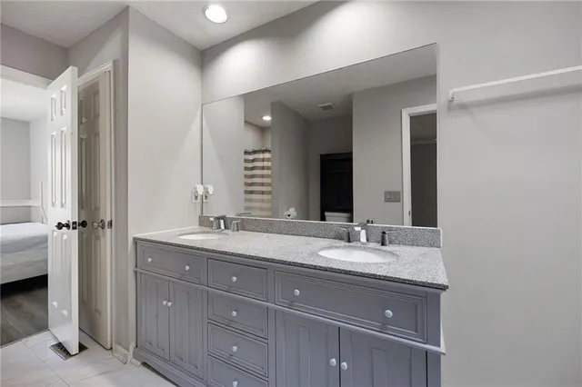 a bathroom with a granite countertop sink double and mirror