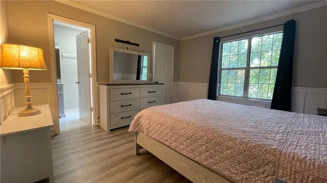 a bedroom with a bed and a dresser