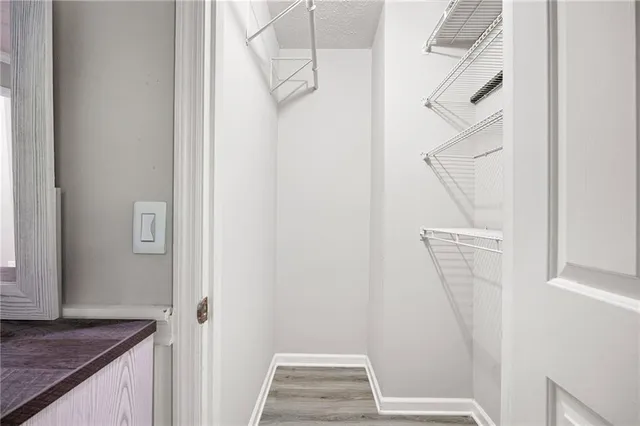 a view of walk in closet with empty racks