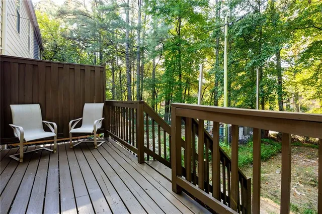 a view of balcony with wooden floor and outdoor seating