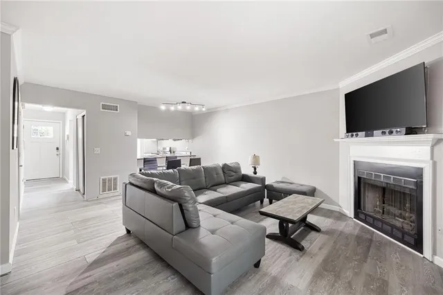 a living room with furniture a flat screen tv and a fireplace