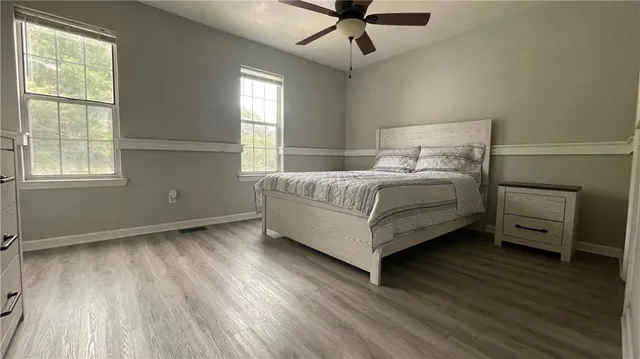 a bedroom with a bed and a ceiling fan