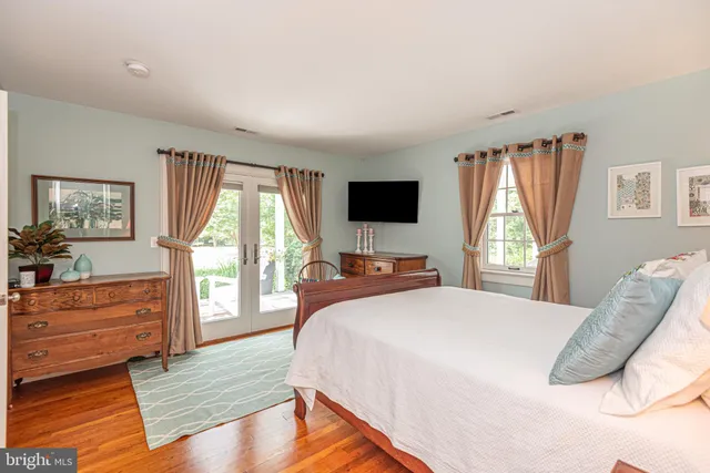 a couple of chairs sitting in middle of yard with trees