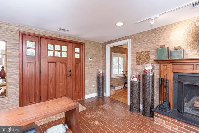 a living room with fireplace furniture and a wooden floor