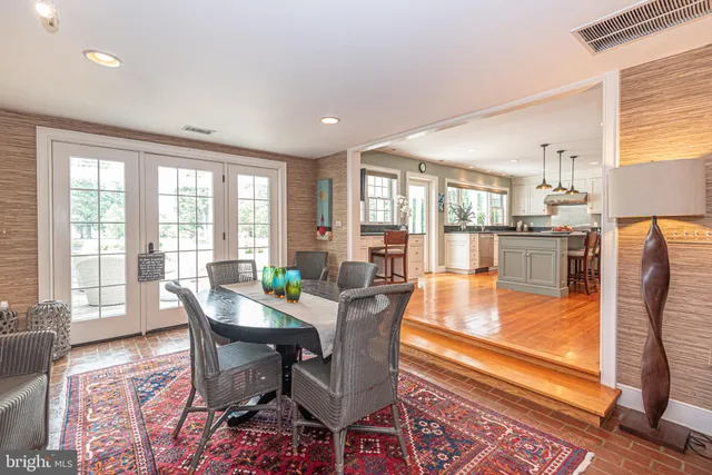 a living room with furniture a flat screen tv and a floor to ceiling window