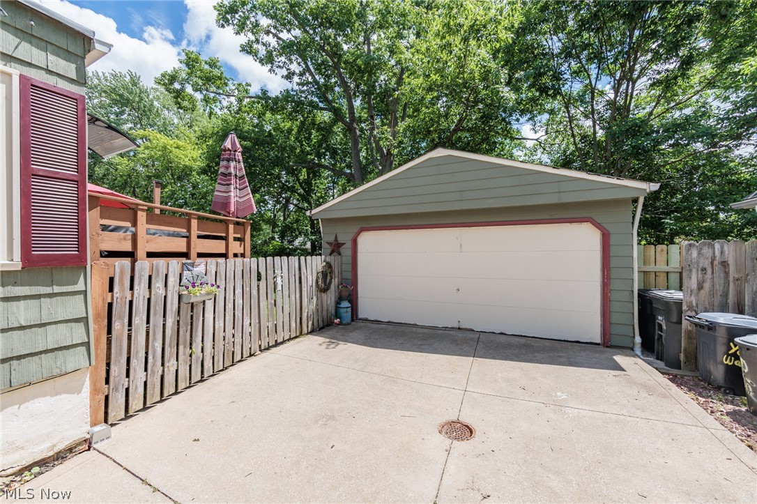 5364 Summit Road Lyndhurst, OH 44124 - Photo 38 of 42 Detached garage with a single overhead door, concrete driveway, and wood privacy fence