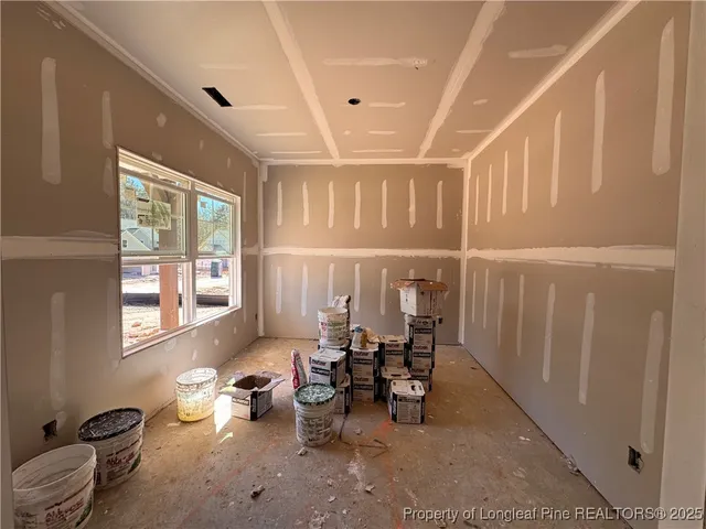 a living room with furniture a window and chairs