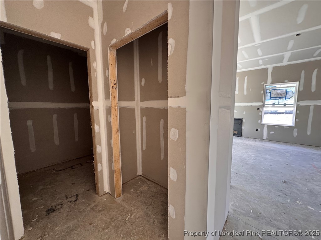 271 Elijah Way Vass, NC 28394 - Photo 5 of 28 a view of a hallway with closet and utility room