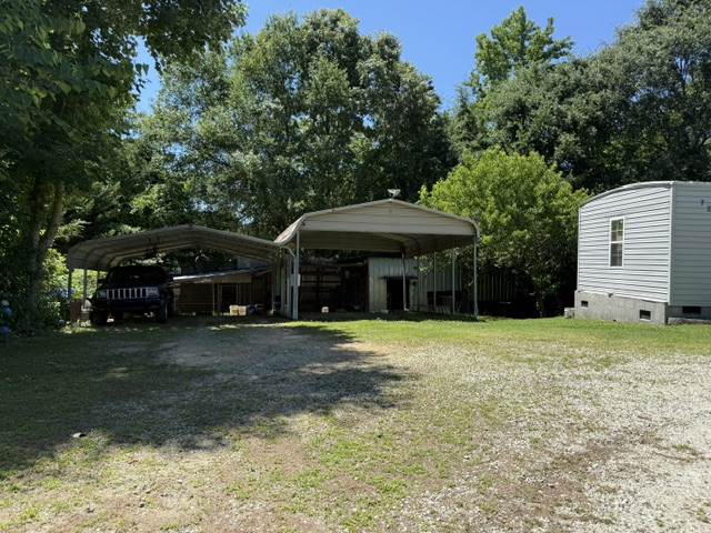 731 Glenn Ferry Road Fair Play, SC 29643 - Photo 2 of 23 A well-maintained yard provides ample space for parking and outdoor activities, with a detached structure and covered parking.