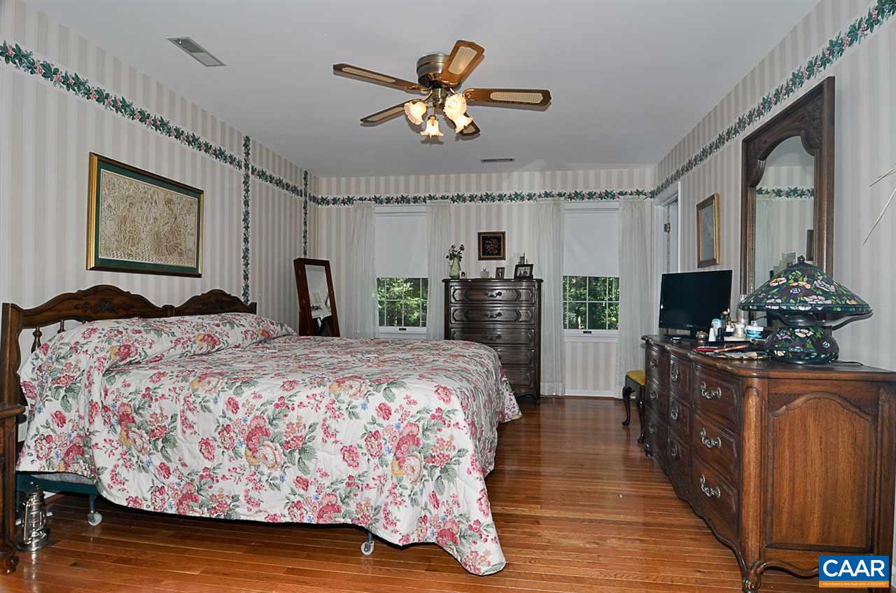2424 Thrush Road Charlottesville, VA 22901 - Photo 17 of 25 a bedroom with a bed and wooden floor