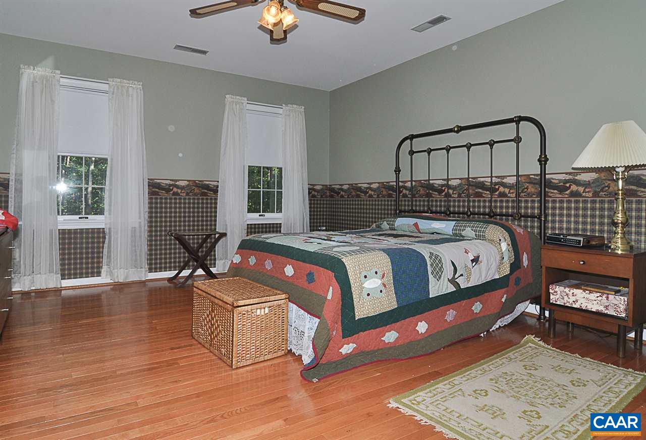 2424 Thrush Road Charlottesville, VA 22901 - Photo 22 of 25 a bedroom with a bed next to a window with the outer view