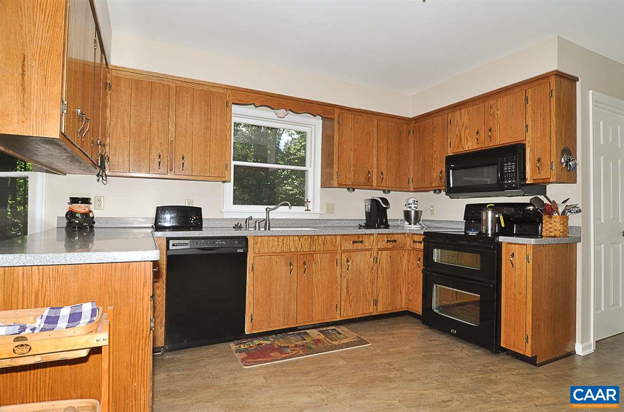 2424 Thrush Road Charlottesville, VA 22901 - Photo 8 of 25 a kitchen with stainless steel appliances granite countertop a stove top oven a sink dishwasher and a refrigerator with wooden floor