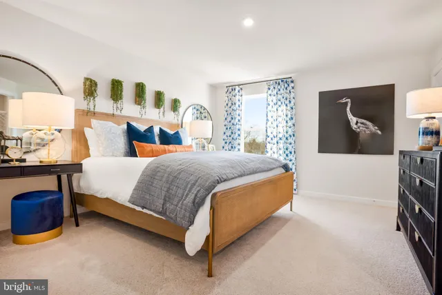 a bedroom with a bed and lamp with window