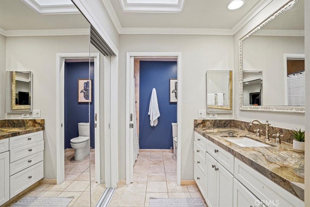 23802 Cassandra Bay Dana Point, CA 92629 - Photo 33 of 56 a spacious bathroom with a granite countertop sink and a mirror