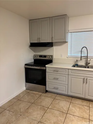 a kitchen with granite countertop a stove top oven and sink