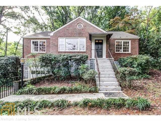 1663 Clifton Road Atlanta, GA 30307 - Photo 1 of 1 a front view of a house with a yard and garage