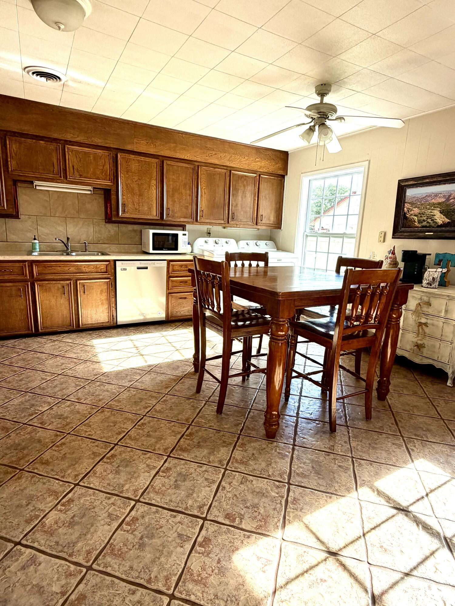 207 2nd Street Quitaque, TX 79255 - Photo 4 of 9 a kitchen with stainless steel appliances kitchen island granite countertop a sink and cabinets