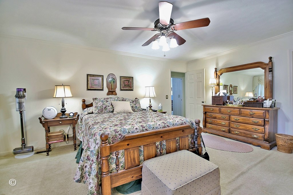 5002 Sears Court Columbus, GA 31907 - Photo 20 of 35 a bedroom with a bed a chandelier and dresser