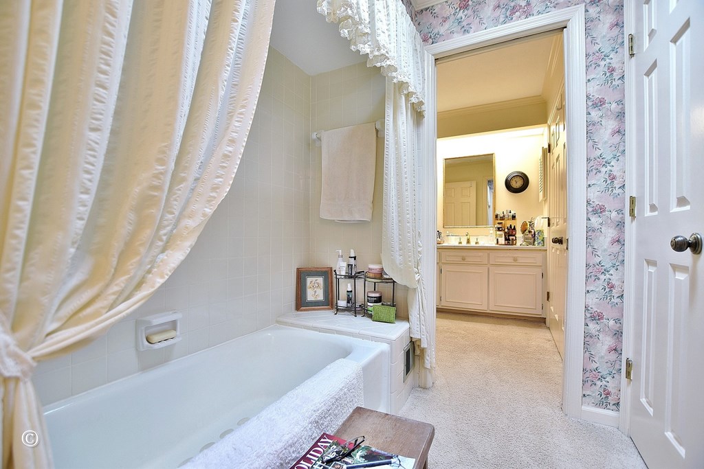 5002 Sears Court Columbus, GA 31907 - Photo 22 of 35 a bathroom with a tub a sink and a large mirror