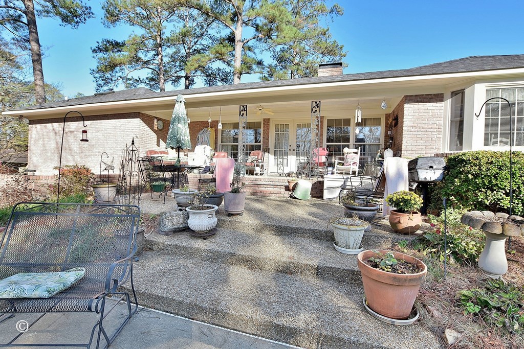 5002 Sears Court Columbus, GA 31907 - Photo 30 of 35 a view of a patio with dining table and chairs potted plants