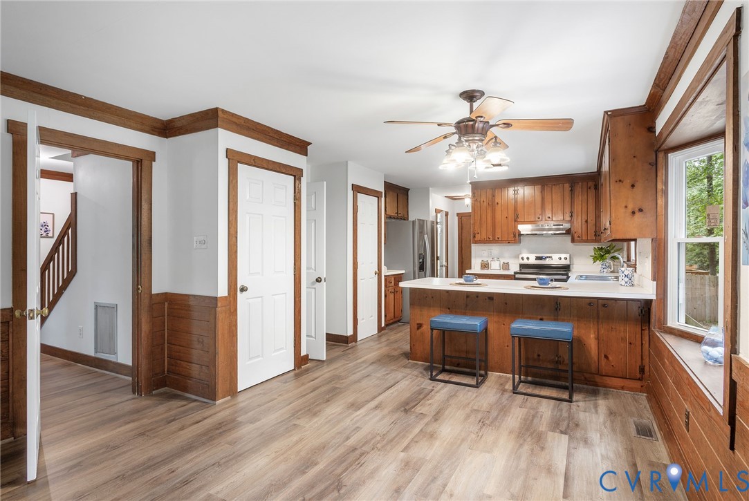 3121 Quail Hill Drive Midlothian, VA 23112 - Photo 10 of 37 a living room with stainless steel appliances granite countertop furniture wooden floor and a kitchen view