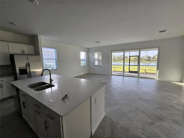 a kitchen with kitchen island a sink and a stove
