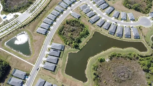 an aerial view of a house with a lake view