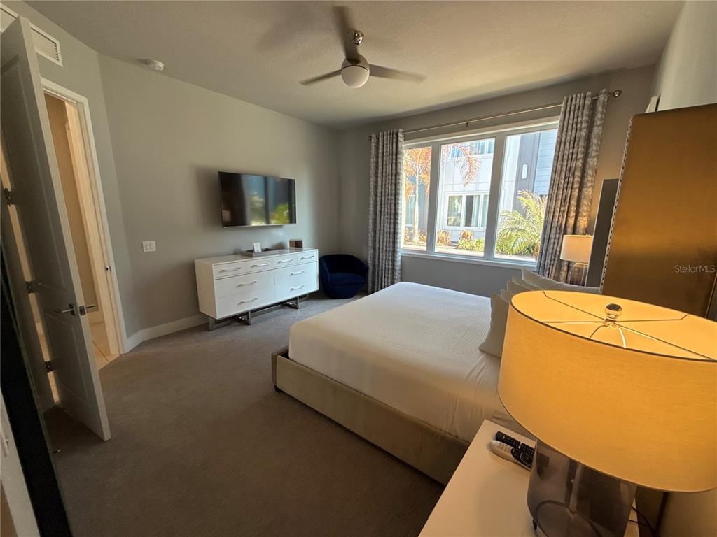 7740 Sandy Ridge Drive, Unit 120 Reunion, FL 34747 - Photo 16 of 36 a bedroom with a bed dresser and a window