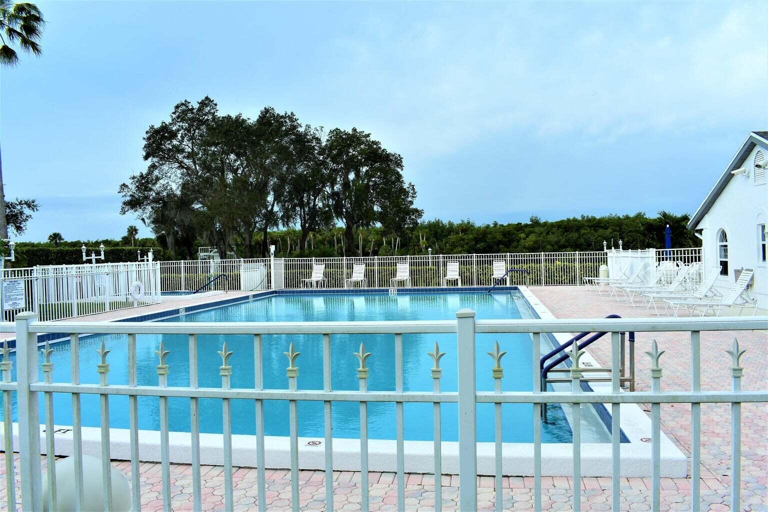 2502 Southeast Anchorage Cove, Unit 3 Port St. Lucie, FL 34952 - Photo 11 of 15 a view of a balcony with wooden floor and fence