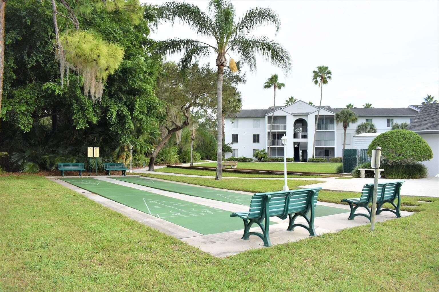 2502 Southeast Anchorage Cove, Unit 3 Port St. Lucie, FL 34952 - Photo 15 of 15 a view of a house with swimming pool and a yard
