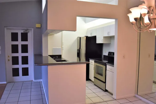 a kitchen with stainless steel appliances a refrigerator sink and microwave