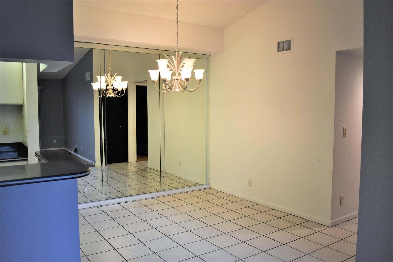 2502 Southeast Anchorage Cove, Unit 3 Port St. Lucie, FL 34952 - Photo 3 of 15 a view of a kitchen from a hallway