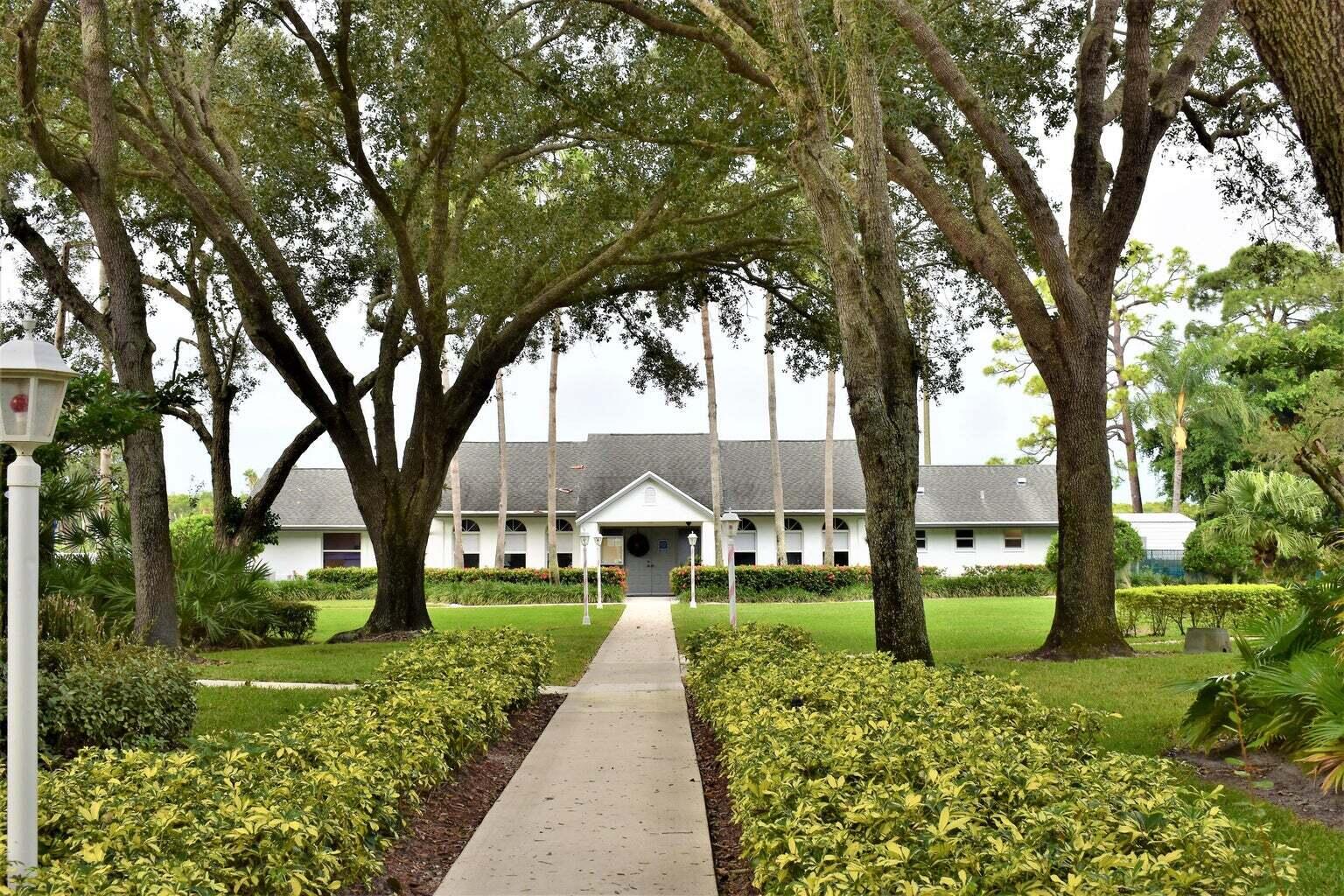 2502 Southeast Anchorage Cove, Unit 3 Port St. Lucie, FL 34952 - Photo 8 of 15 a house with trees in front of it