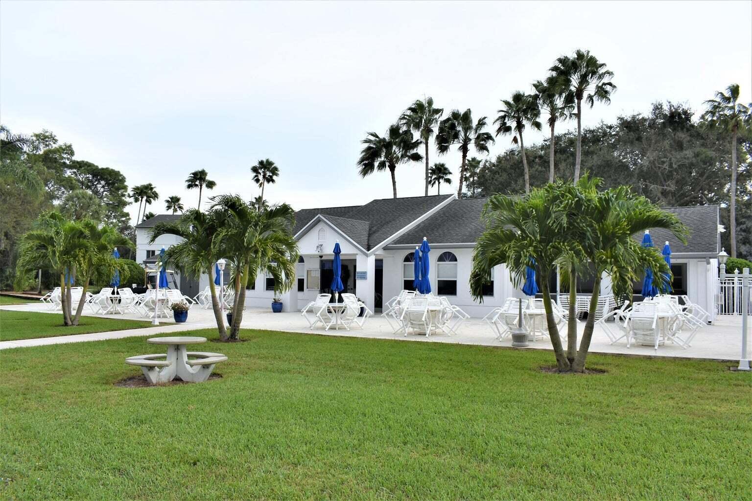 2502 Southeast Anchorage Cove, Unit 3 Port St. Lucie, FL 34952 - Photo 10 of 15 a view of a house with a backyard porch and sitting area