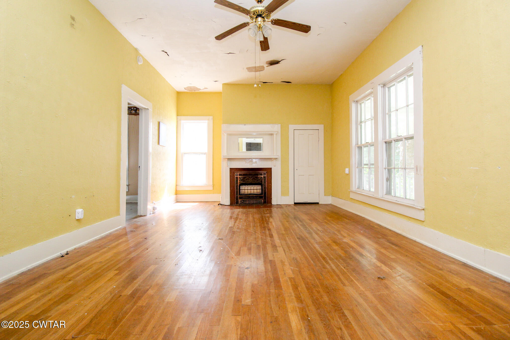 1352 Whitehall Street Jackson, TN 38301 - Photo 5 of 34 a view of an empty room with a fireplace and a window