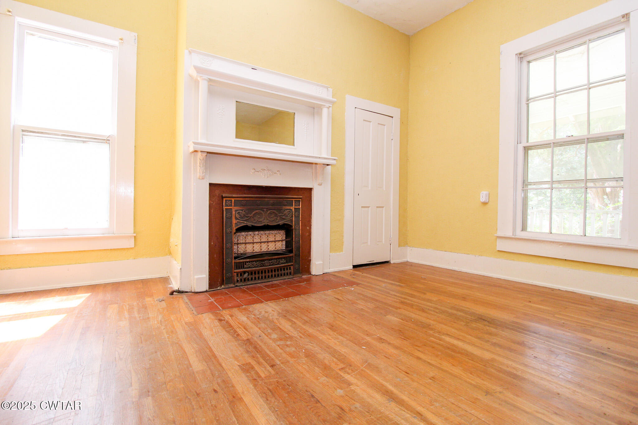 1352 Whitehall Street Jackson, TN 38301 - Photo 6 of 34 a view of empty room with a fireplace and wooden floor