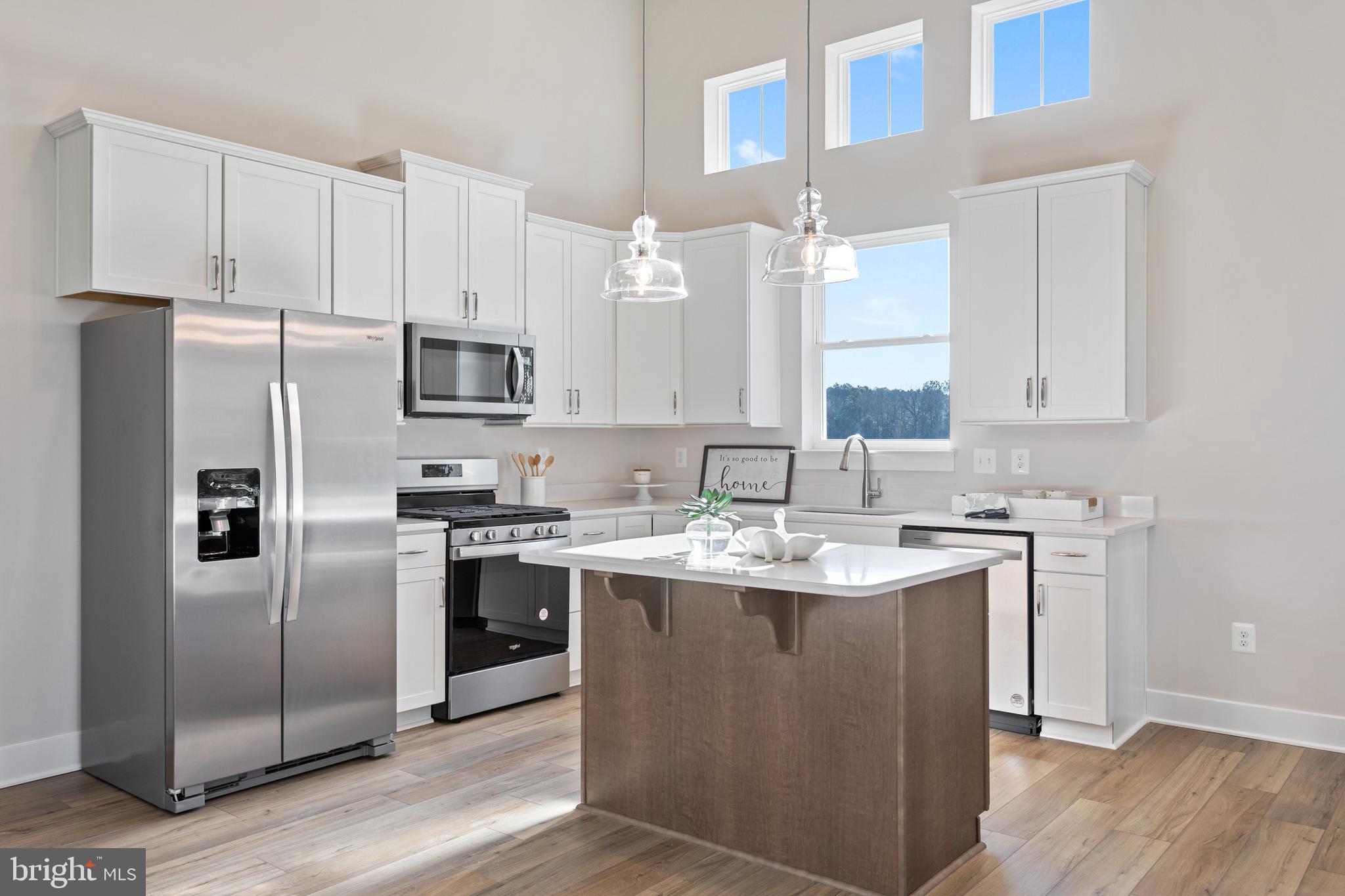 Tbb Wetherby Circle, Unit ALOHA Millsboro, DE 19966 - Photo 2 of 21 a kitchen with stainless steel appliances granite countertop a sink stove and refrigerator